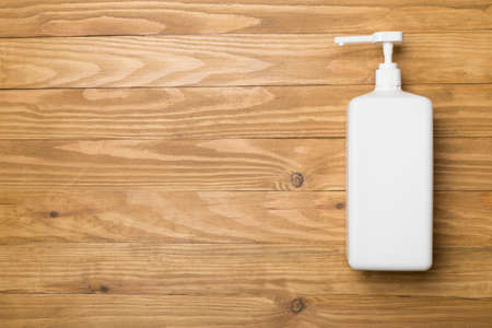 Hand sanitizer in white bottle on wooden background.の写真素材