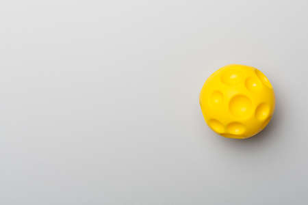 Yellow spikey ball toy for pet on color background.の写真素材