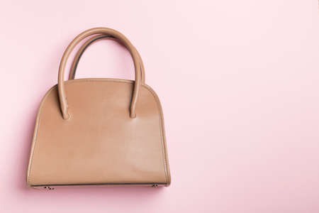 Fashionable woman bag on color background. top view.の写真素材