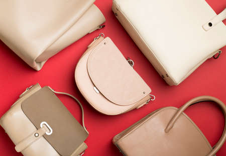 Fashionable woman bag on wooden background. top view.の写真素材