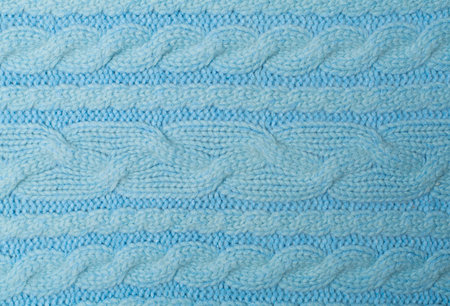 Knitted woolen sweater as background, closeup.