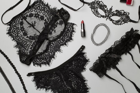 Set of black sexy lace lingerie with accessories on color background, top view.の写真素材