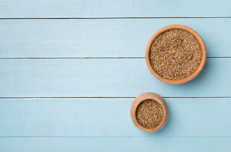 Wholegrain spelt farro in bowl on wooden background. top view.の写真素材