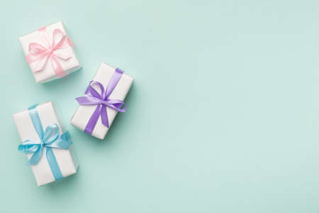 Colorful gift boxes on color background, top view.