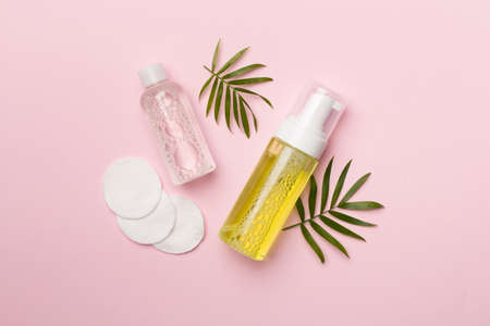 Foaming facial cleanser and micellar water on color background, top view.の写真素材