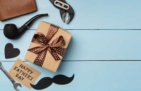 Happy Father's Day inscription with different gifts on wooden background, top view.の写真素材