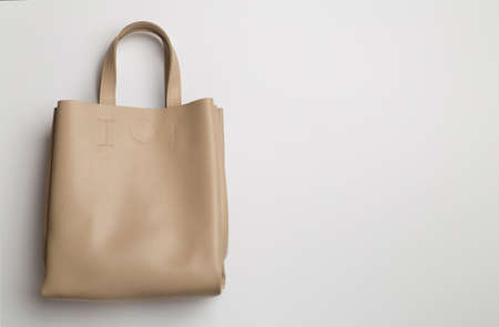 Fashionable woman bag on color background. top view.の写真素材