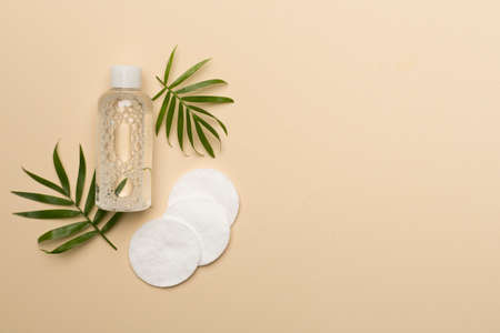 Micellar cleansing water and cotton pads on color background, top view.の写真素材