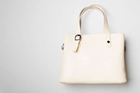 Fashionable woman bag on color background. top view.の写真素材