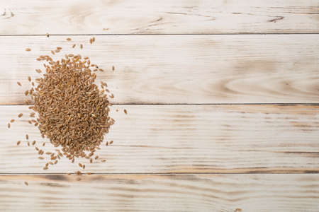 Wholegrain spelt farro on wooden background. top view.の写真素材