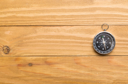 Old compass on wooden background.の写真素材