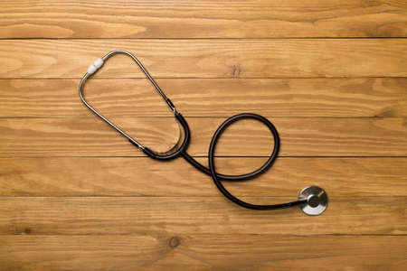 Stethoscope on wooden background, top view.の写真素材