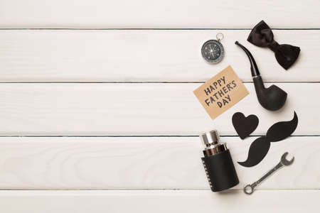 Happy Father's Day inscription with different gifts on wooden background, top view.の写真素材
