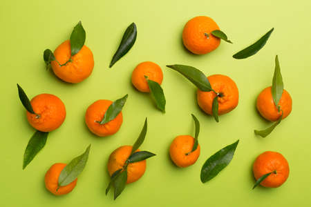 Flat lay with fresh tangerines on color background.の写真素材