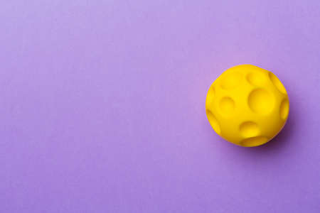 Yellow spikey ball toy for pet on color background.の写真素材