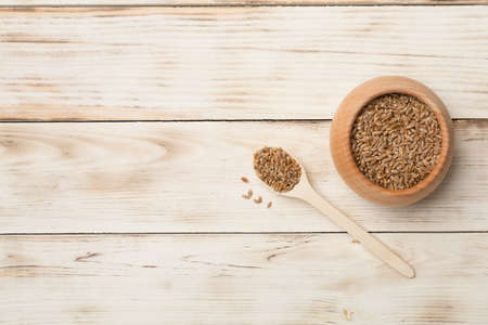 Wholegrain spelt farro in bowl on wooden background. top view.の写真素材