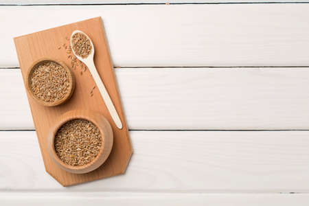 Wholegrain spelt farro in bowl on wooden background. top view.の写真素材