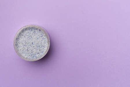 Natural scrub in container on color background, top view.の写真素材