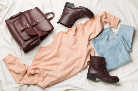 Flat Lay with women casual outfit on white bed sheet, top view.の写真素材