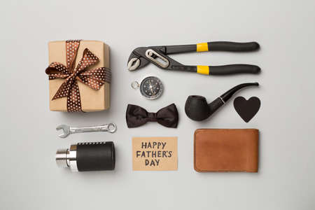 Happy Father's Day inscription with different gifts on color background, top view.の写真素材