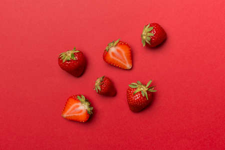 Fresh strawberries on color background, top view.