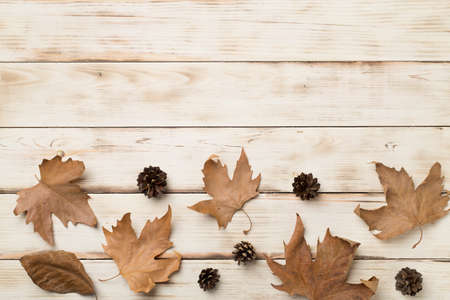 Flat lay composition with autumn leaves on wooden background, top view.