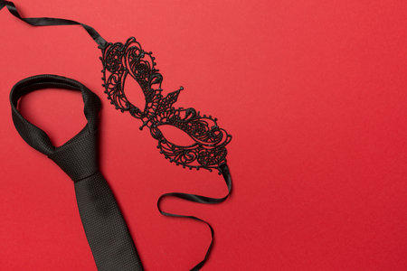Lace mask and tie on color background, top view.の写真素材