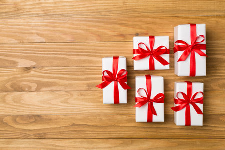 Top view of gift boxes on wooden background.