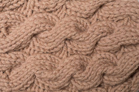 Knitted woolen sweater as background, closeup.