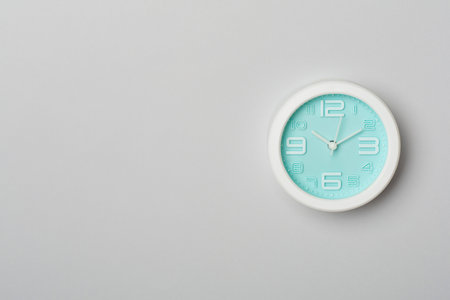 Blue clock on color background, top view.