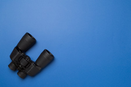 Black binoculars on color background. Top view.の写真素材