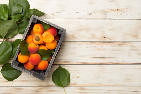 Composition with ripe apricots on wooden background, top view.の写真素材