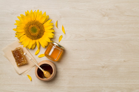 Flat lay with sunflower honey on wooden background, top view.の写真素材