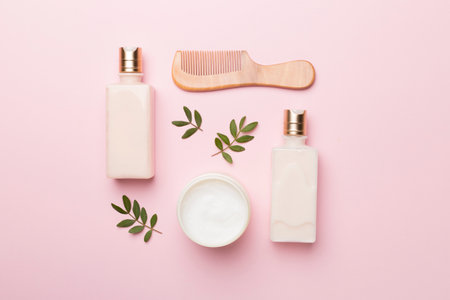 Shampoo and conditioner with herbal extract and comb on color background, top view.の写真素材