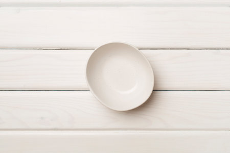 Empty round plate on wooden background, top view.の写真素材