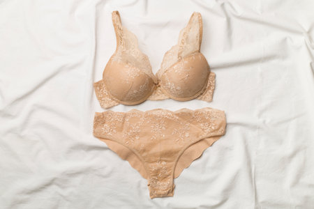 Flat Lay with women romantic underwear on white bed sheet, top view.の写真素材
