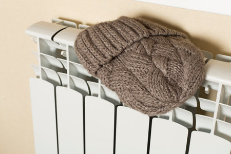 Bimetallic radiator with hat indoors. Winter heating concept.の写真素材