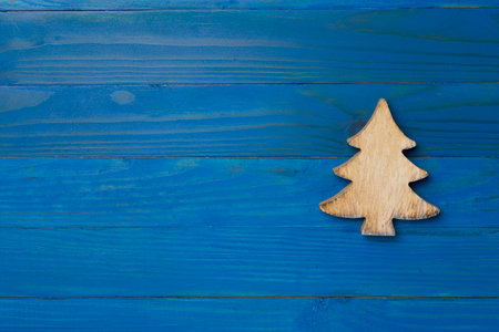 Wooden Christmas tree on wooden background, top view.の写真素材