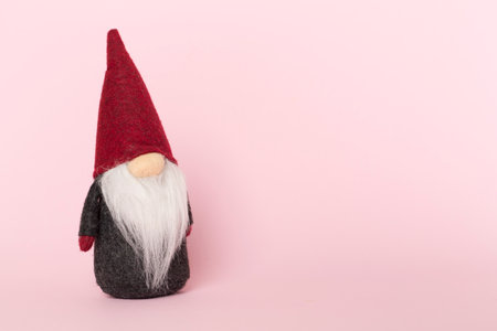 Small Christmas dwarf on color background.の写真素材