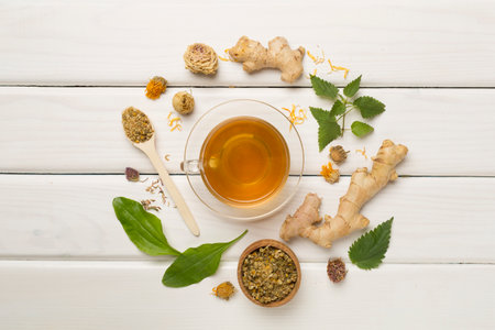 Herbal tea with ingredients on wooden background, top view.の写真素材