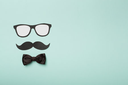 Glasses, mustache and bow tie on color background, top view. Happy Father's Day concept.の写真素材