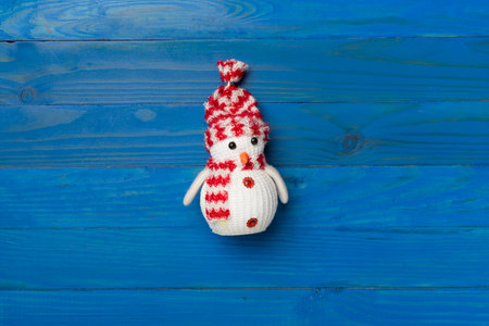 Small Christmas snowman on wooden background, top view.の写真素材