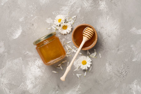 Composition with fresh honey on concrete background, top view.の写真素材