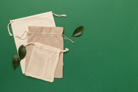 Small eco sacks with green leaves color on background. Top viewの写真素材