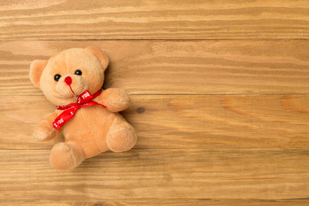 Cute teddy bear on wooden background, top viewの写真素材