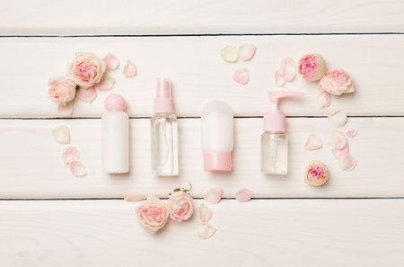 Set of small cosmetic bottles on wooden background, top view.の写真素材