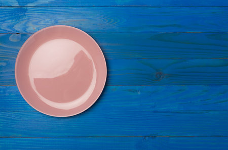 Empty round plate on wooden background, top view,の写真素材