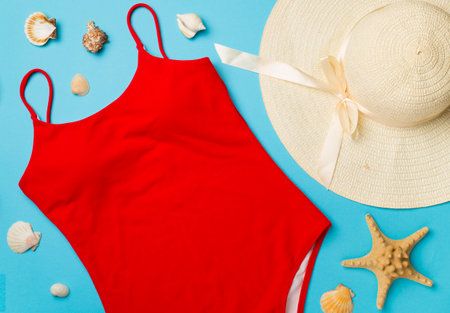 Beautiful red bikini and accessories on color background, top view.の写真素材