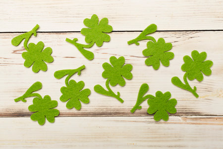 Felt clover on wooden background, top view. St. Patricks day concept