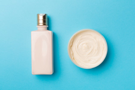 Shower gel and body cream on color background, top view.の写真素材